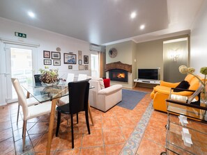 Cozy living space with a fireplace, comfortable seating, and a TV.