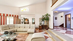A spacious living area with a sectional sofa, a glass coffee table, and a large potted plant. - Monte Meco by Interhome (Silves)