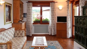A living room with a sofa, a coffee table, a TV, and a cabinet. - Pancheri by Interhome (Valle di Non)