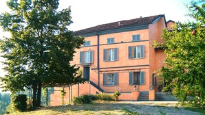 A two-story building with a symmetrical facade, a central staircase, and a gravel driveway. - Cascina Villa (AST231) by Interhome (Asti)
