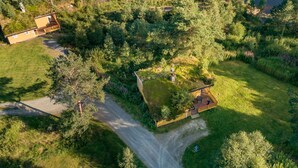 An aerial view of a secluded property with a house surrounded by dense forest, a clear path leading to the house, and a small dock by the water. - Synnøve by Interhome (Hellevik I Fjaler)