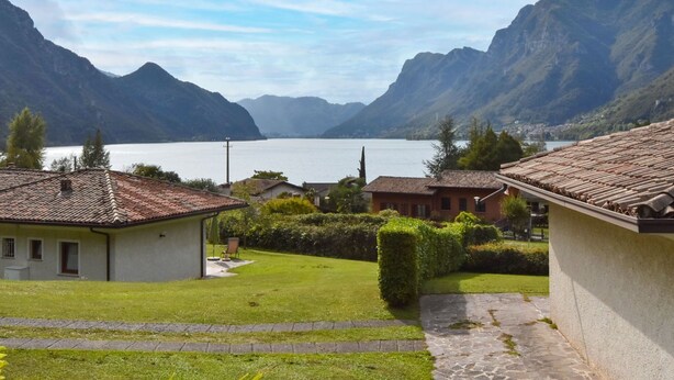 A lakeside view with terraced houses and mountains in the background. - Villa Vesta by Interhome (Lago d'Idro)