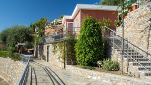 A stone staircase leading up to a building with a balcony. - Gelsomino (SLR403) by Interhome (San Lorenzo al Mare)