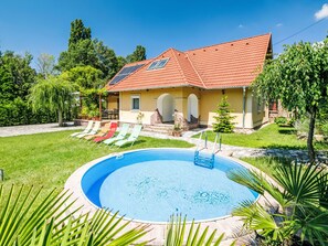 A house with a swimming pool, a garden, and a patio with chairs. - Horvath by Interhome (Abrahamhegy)
