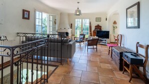 A spacious living area with a fireplace, television, and seating. - La Garance by Interhome (Grasse)