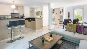 A modern apartment with a kitchen, dining area, and living room. - Les Rives du Golf 3 by Interhome (Roquebrune sur Argens)