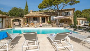 A stone villa with a swimming pool, outdoor seating, and a large tree. - La Crischona by Interhome (Les Issambres)