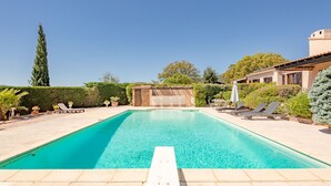 A rectangular swimming pool with clear blue water, surrounded by a tiled deck. - Le Mas d'Olive by Interhome (Grimaud)