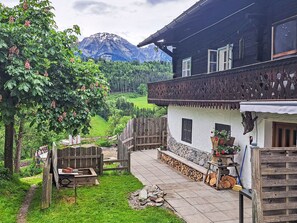 A traditional chalet with a stone foundation, wooden balcony, and a view of a mountainous landscape. - Vacation home Lehen by Interhome (Sankt Veit im Pongau)