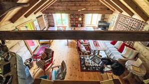 A cozy attic room with wooden beams, a large window, and a view of the outdoors. - Haukedalspanorama by Interhome (Haukedalsvatn)