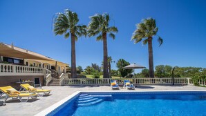 A pool area with lounge chairs and palm trees. - Quinta do Mosaico by Interhome (Lagos)