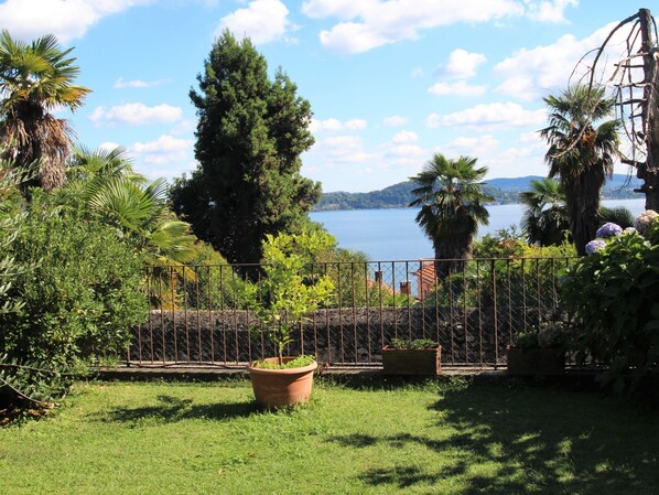 A garden with a view of a lake and mountains.