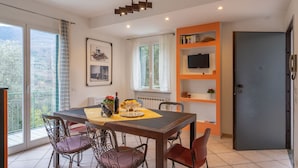 A dining area with a table, chairs, and a view of the outdoors.