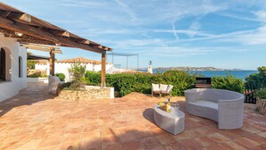 A patio with outdoor furniture, a pergola, and a view of the sea. - Vacation home Anita by Interhome (Palau)