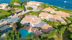 A coastal residential area with terraced houses, a swimming pool, and boats in the background. - Vacation home Anita by Interhome (Palau)