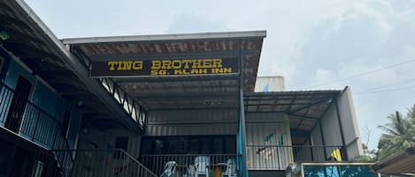 A multi-story building with a sign for 'Ting Brother SG. Klay Inn'.