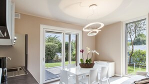A modern kitchen with a built-in oven and a stainless steel sink. - Iris e Girasole by Interhome (Manerba)