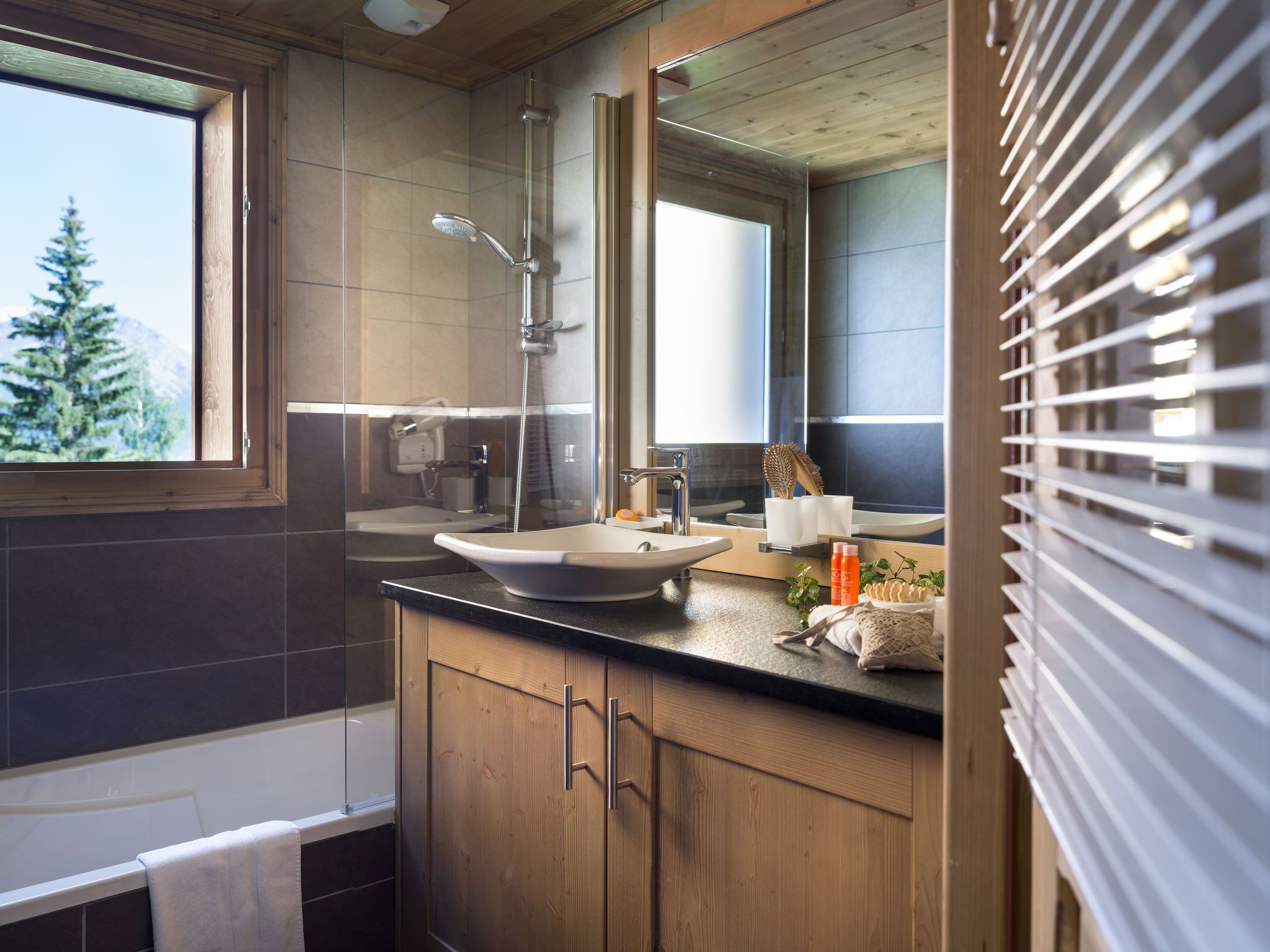 A modern bathroom with a bathtub, a sink, and a shower.