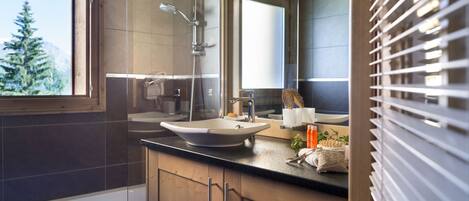 A modern bathroom with a bathtub, a sink, and a shower.