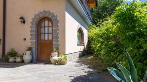 A building with a stone facade, a wooden door, and a balcony with wrought iron railings.