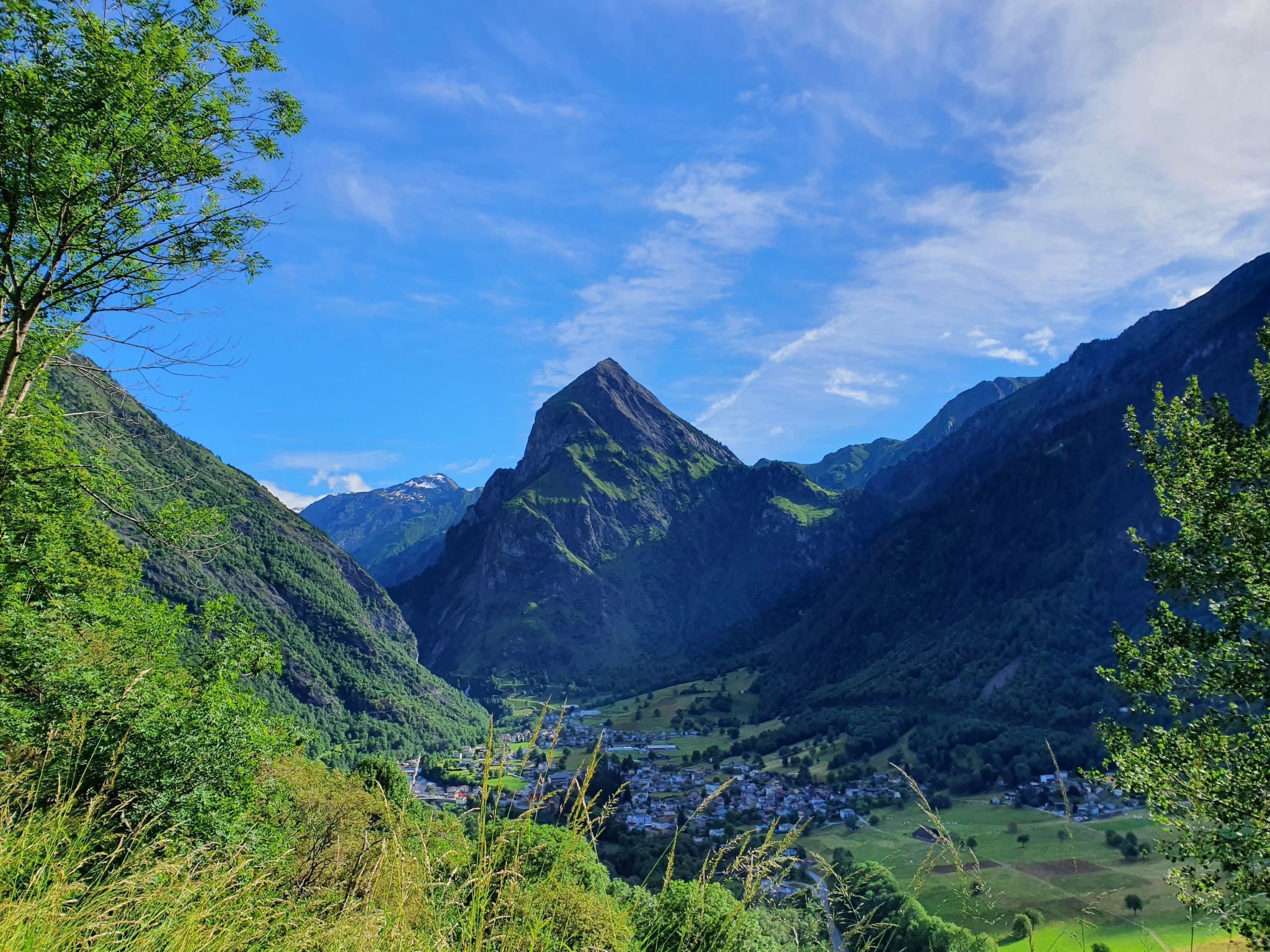 A mountainous landscape with a valley and a small town.