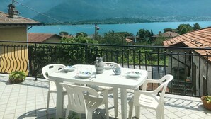 A terrace with a table set for two, overlooking a lake and mountains. - Elisabetta (GLA116) by Interhome (Gera Lario)