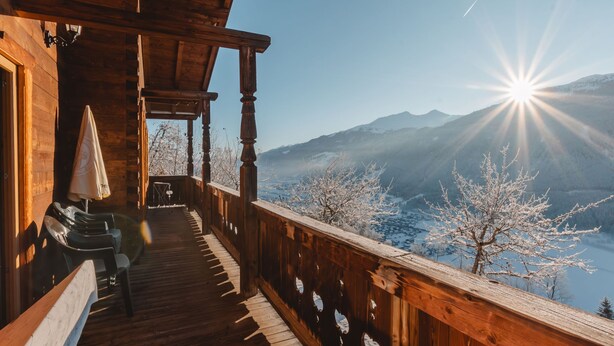 A wooden balcony with a view of snow-covered trees and mountains. - Geislhof by Interhome (Bramberg am Wildkogel)