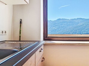 A kitchen with a window view of a mountainous landscape. - Tobias 1 by Interhome (Radstadt)
