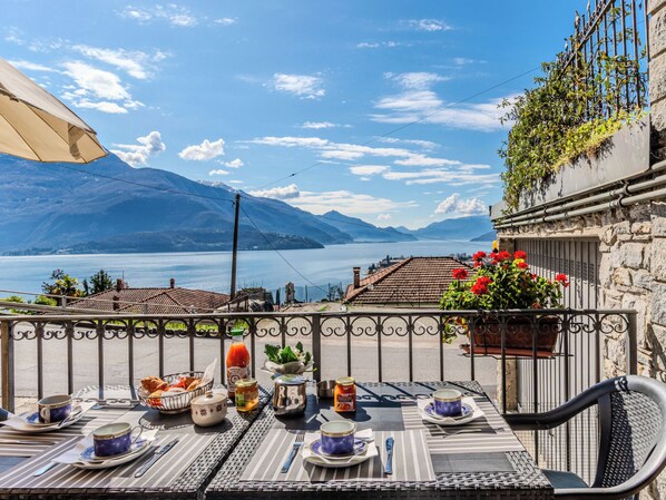 Een eettafel met uitzicht op een meer en bergen.