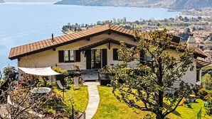 A house with a patio, a small pool, and a view of a lake and mountains. - Bellavista by Interhome (Gravedona)