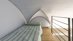 A small, narrow room with a single bed, wooden floor, and a metal railing. - Cielo e Mare (FLG111) by Interhome (Finale Ligure)