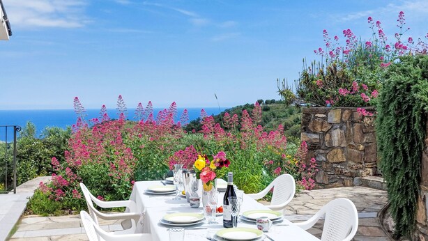 A table set for dining with a view of the sea and pink flowers in the background. - Settimo Cielo (DOL400) by Interhome (Dolcedo)