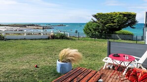 A patio with a view of the sea, a white fence, and a potted plant. - Ti an Aod by Interhome (Cléder)