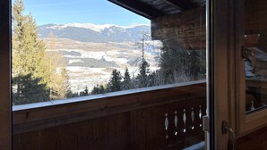 A wooden cabin with a large window overlooking a mountainous landscape. - Apartment Daniel by Interhome (Mittersill)