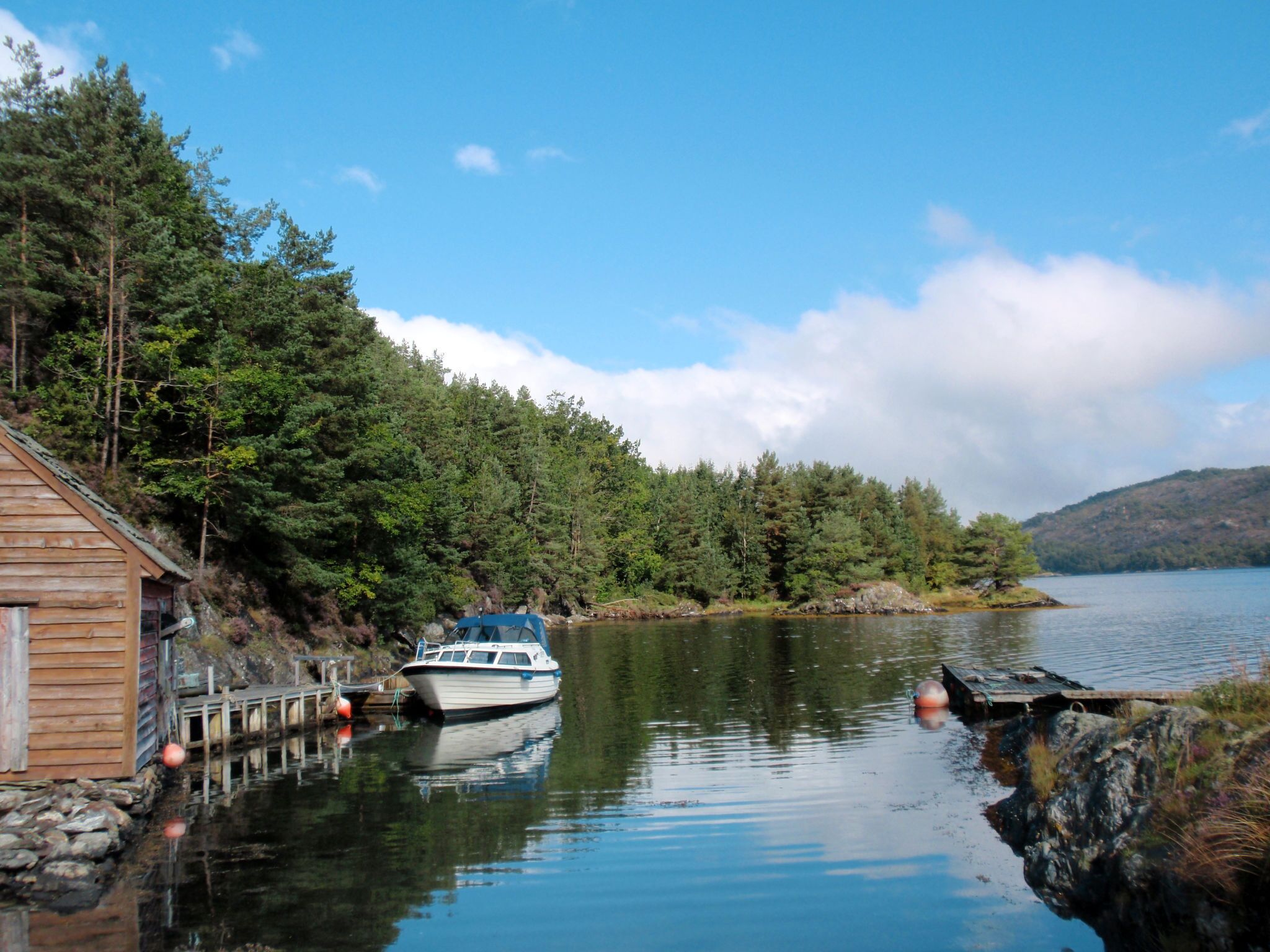 A cabin with a dock and a boat.