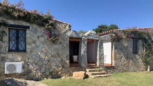 Un edificio de piedra con una escalera de piedra que conduce a un vano abierto.