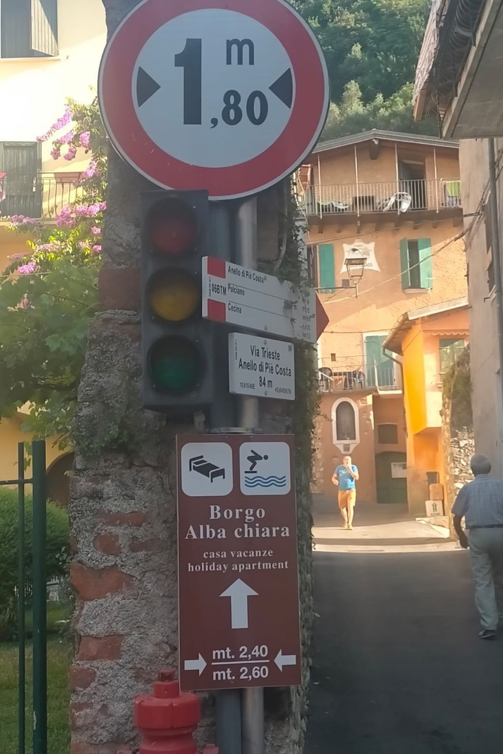 A street sign with directions to various locations, including a holiday apartment.
