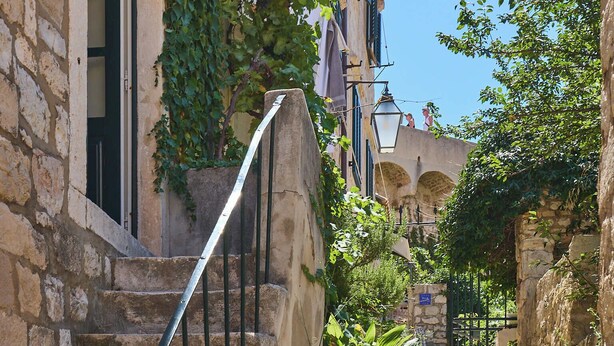 A stone staircase with metal railings leading to a building with ivy-covered walls. - Hedera Estate, Hedera Studio 7 (Dubrovnik)