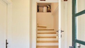 A staircase with wooden steps leading to a landing, a white door on the left, and a green door on the right. - Hedera Estate, Hedera Studio 7 (Dubrovnik)
