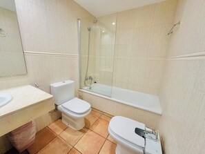 A bathroom with a toilet, bidet, and bathtub. - Port Pals Sea View by Interhome (Pals)