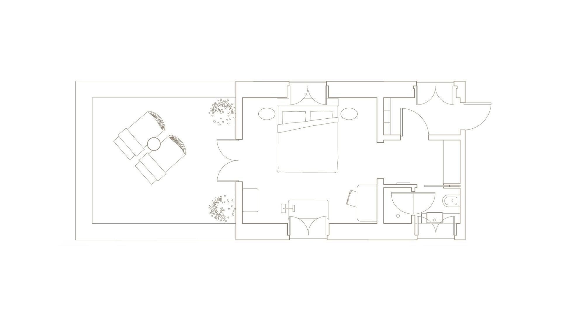 A floor plan of a hotel room with a bed, a bathroom, a kitchen area, and a seating area.