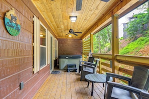 A wooden deck with a ceiling fan, a hot tub, and outdoor seating. - 2 Mi to Dtwn Gatlinburg: 'crescent Claw Cabin!' (Gatlinburg)