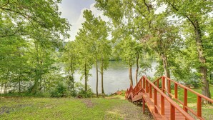 A wooden bridge leading to a lake surrounded by trees. - Flippin Home w/ Fire Pit: Walk to White River! (Flippin)