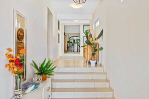 A staircase leading to a room with a view of the outdoors. - Aruba Private Pool Oasis: 5BR near Amazing Beaches (Noord)