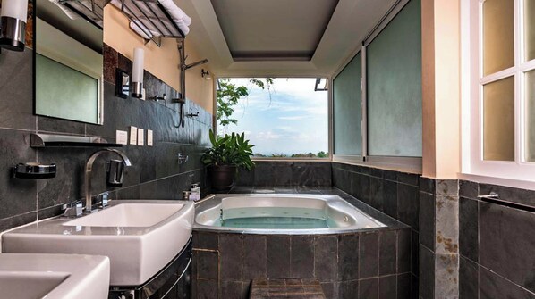 Une salle de bain moderne avec deux lavabos, une baignoire et une grande fenêtre offrant une vue dégagée.
