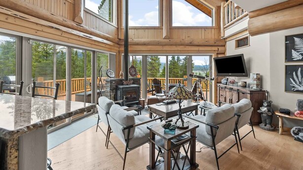 A spacious wooden interior with a large dining area, a fireplace, and a television. - NEW LISTING | 4BD Log Home in Twin Lakes, Amazing Views, Pets OK (Twin Lakes)