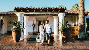 A couple walking towards a building with a tiled roof and columns. - Santa Rosa Cove #61 - 3 bedrooms, 3.5 Baths (La Quinta)