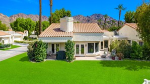 A modern house with a tiled roof, a covered patio, and a well-maintained lawn. - Santa Rosa Cove #61 - 3 bedrooms, 3.5 Baths (La Quinta)