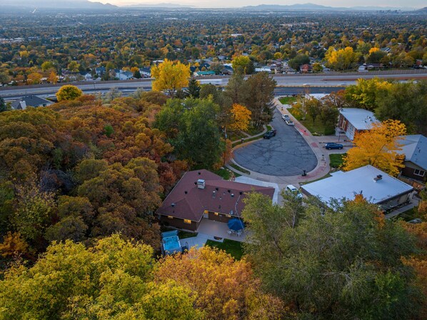 An aerial view of a residential area with houses, roads, and a large parking lot.