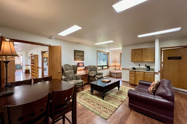 Second living room with cozy seating and a game table that seats 4